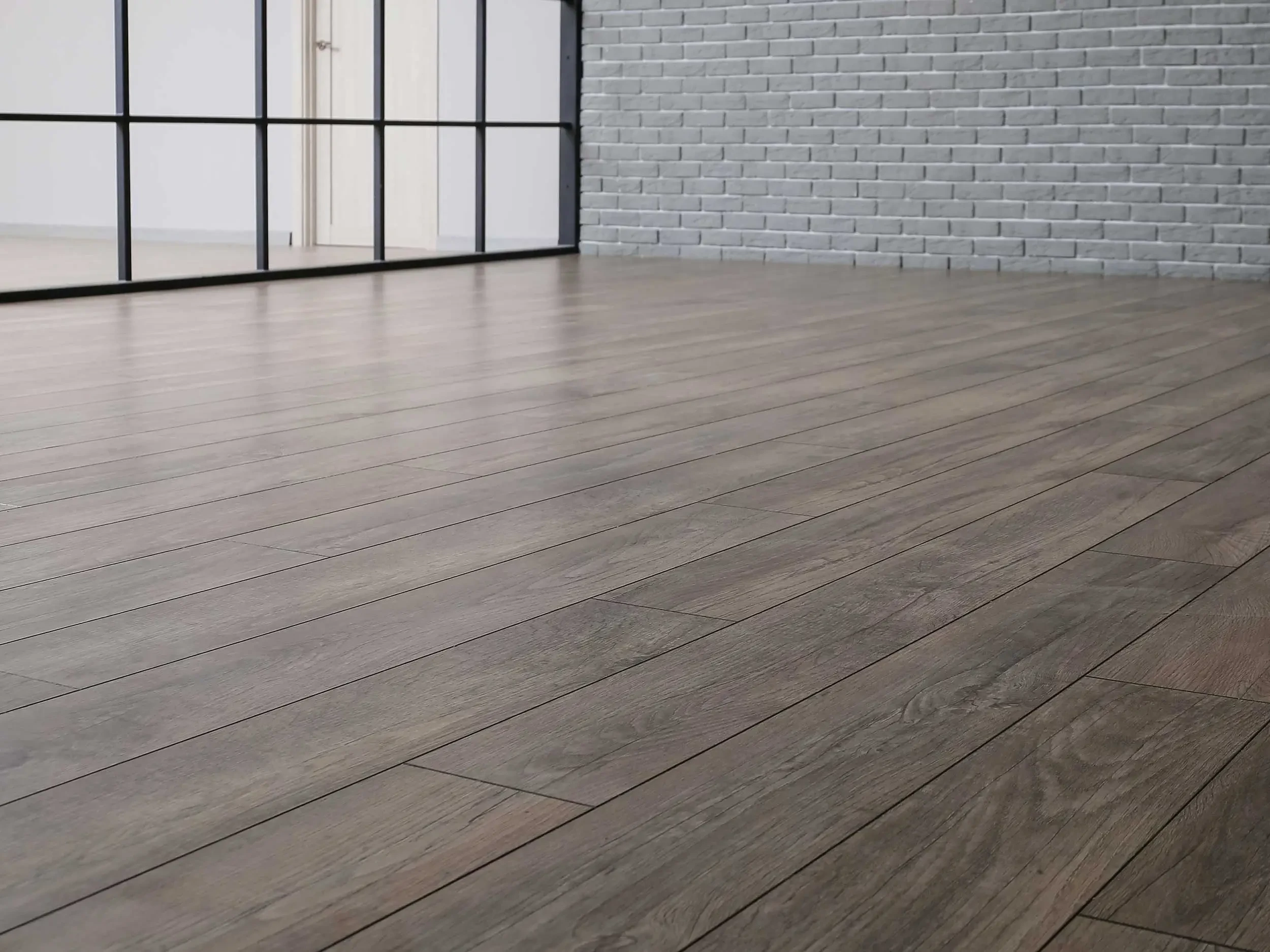 Empty room with clean embossed laminate flooring.