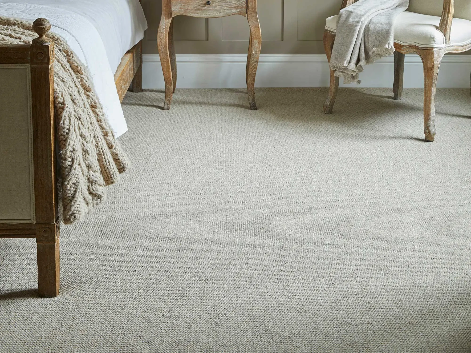 Light coloured loop carpet in a master bedroom.
