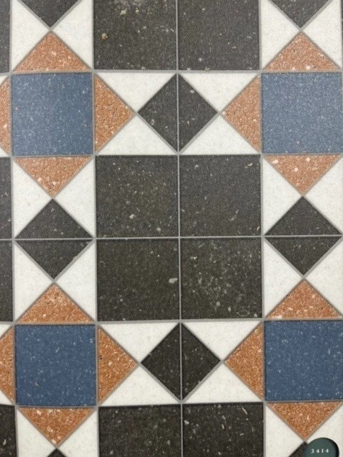 Close up of a geometric vinyl tile sample with square and diamond shapes.