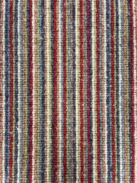 Close up of multi coloured striped carpet.