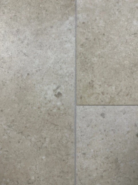 Close up of vinyl tile effect sample in a stone style.
