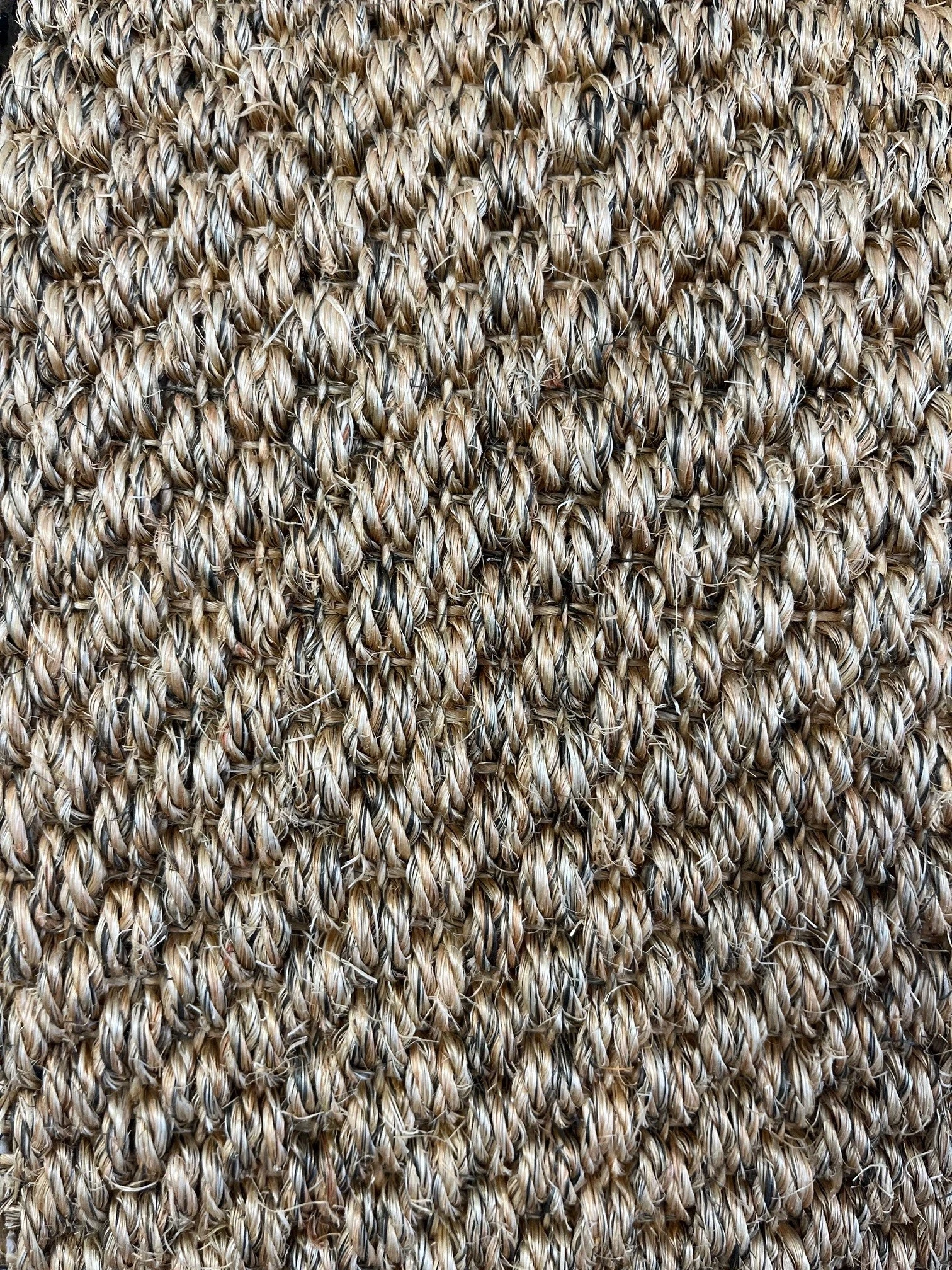 Close up of a sisal carpet in a light colour.
